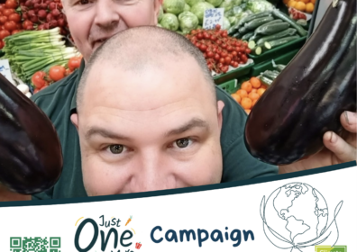 Just One More at Leeds Markets two men at veg stall at leeds market holding up an aubergine fruit and veg in background