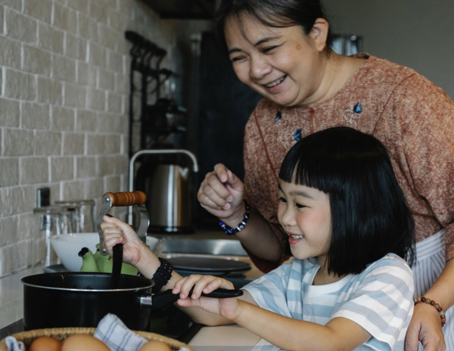 cooking two east asian people cooking
