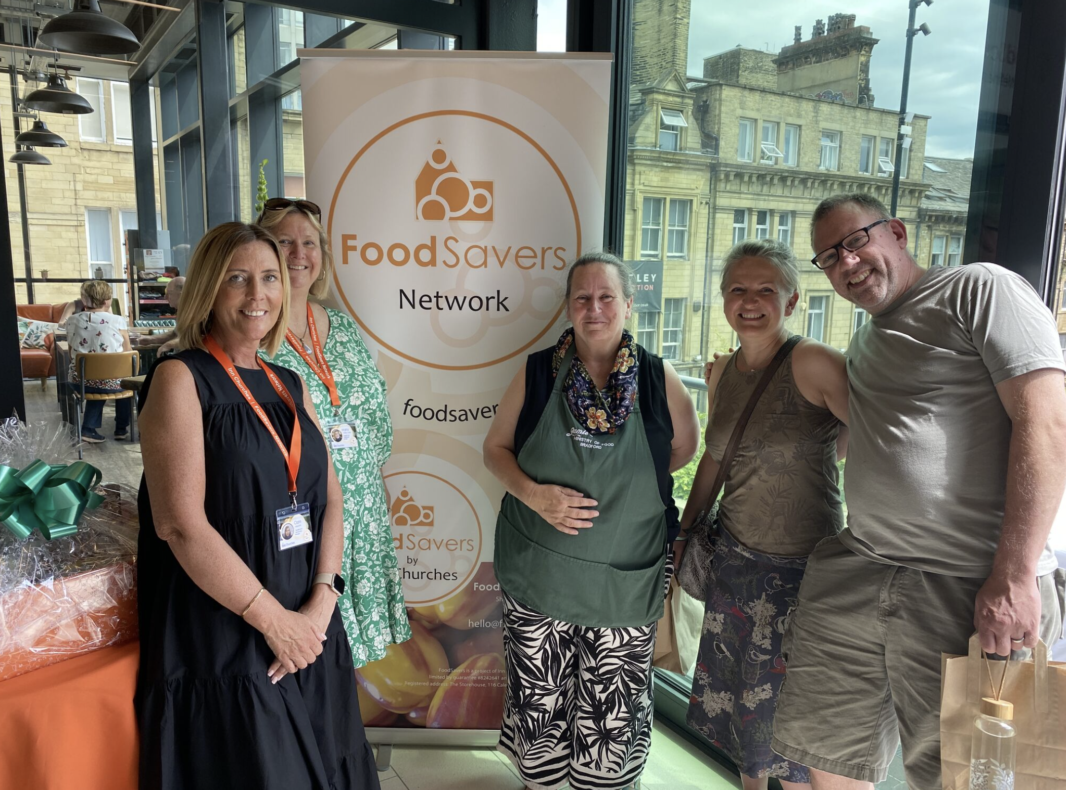 foodsavers network at Wellnest darley street market 5 people with foodsavers network sign at wellnest centre bardford