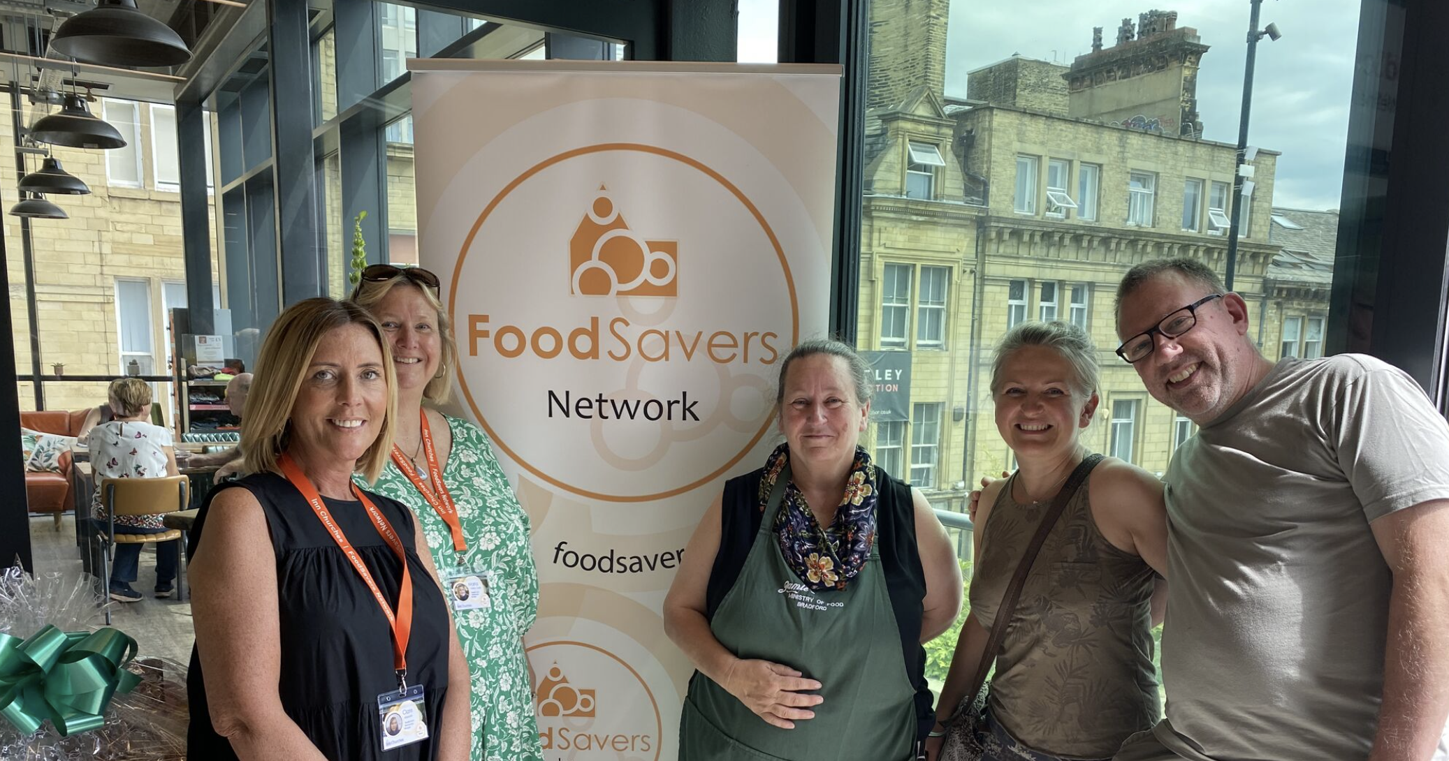 5 people with foodsavers network signage