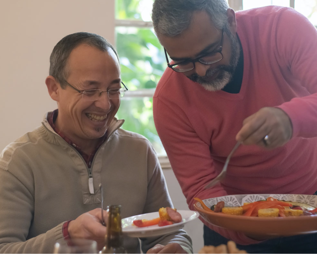healthy eating two men smiling with plate sof healthy vegetable