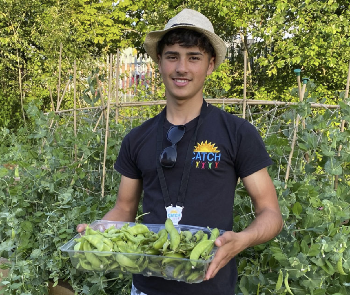 Catch Leeds seasonal veg young person from catch holding tray of seasonal veg